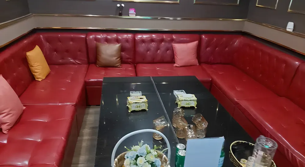 빨간 소파가 둘러싼 가라오케 공간